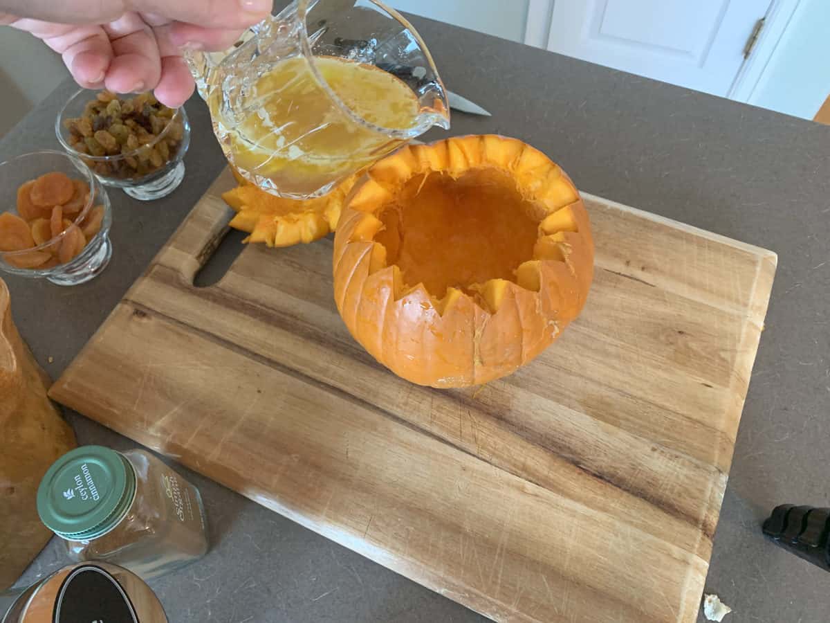 Pouring the clarified putter into th pumpkin. 