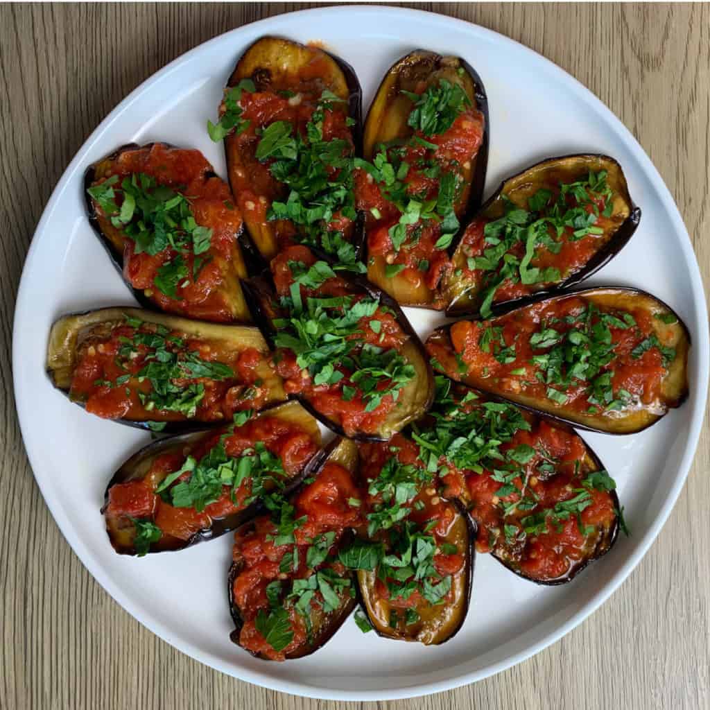 Pan Fried Eggplant with Tomato Confit on a plate. 