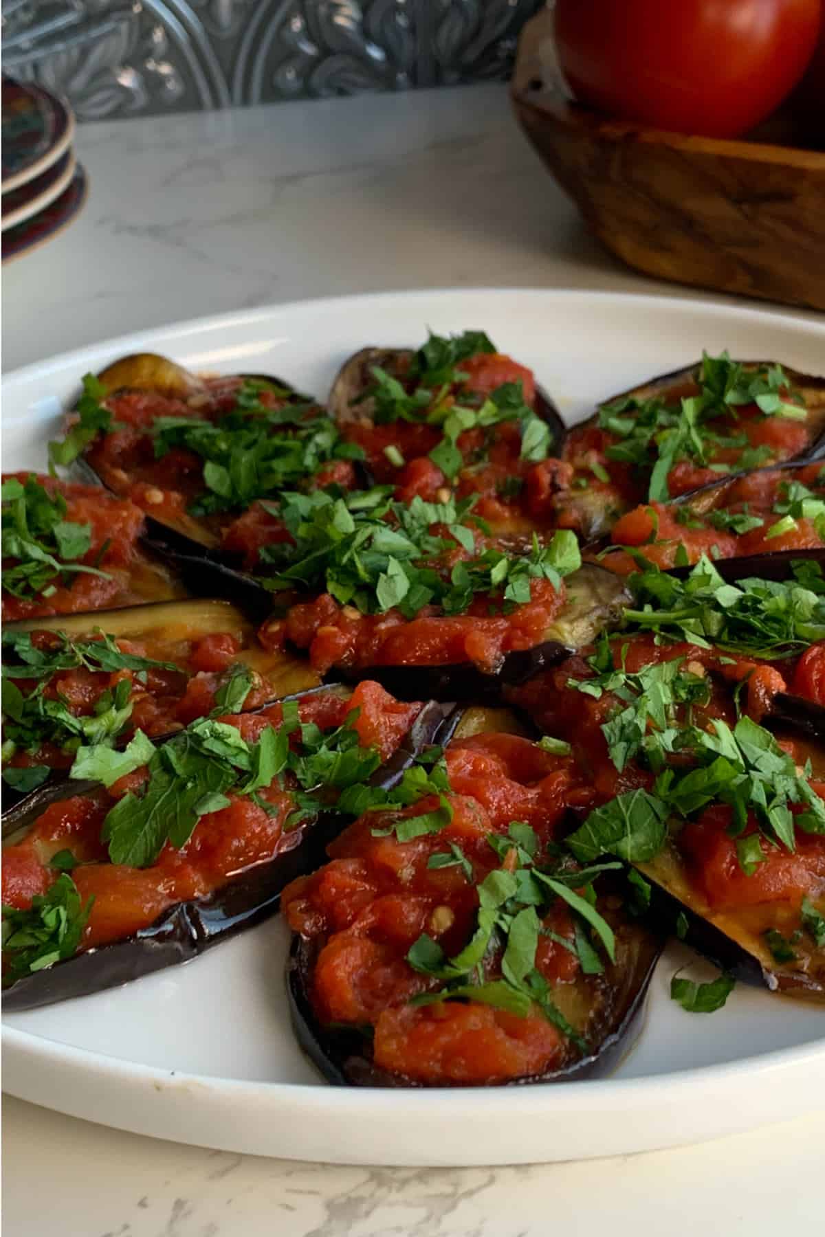 The Eggplant with Tomato Confit served on a dish. 