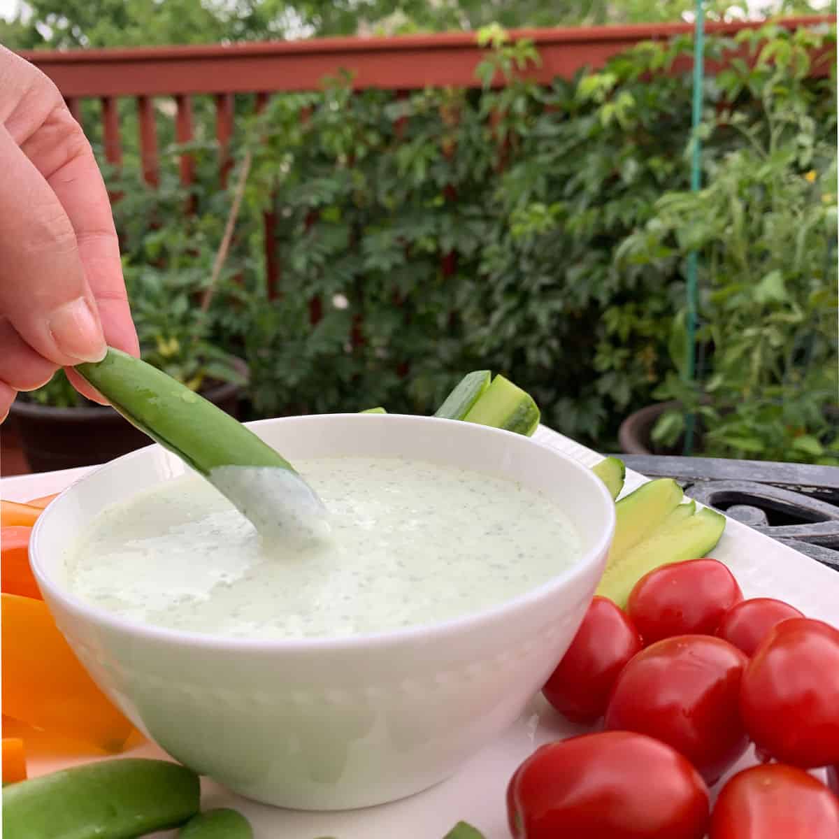 Dipping fresh pea into the whipped feta dip.