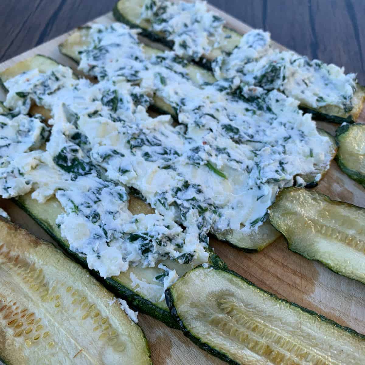 Spinach ricotta cheese filling spread on fried zucchini.
