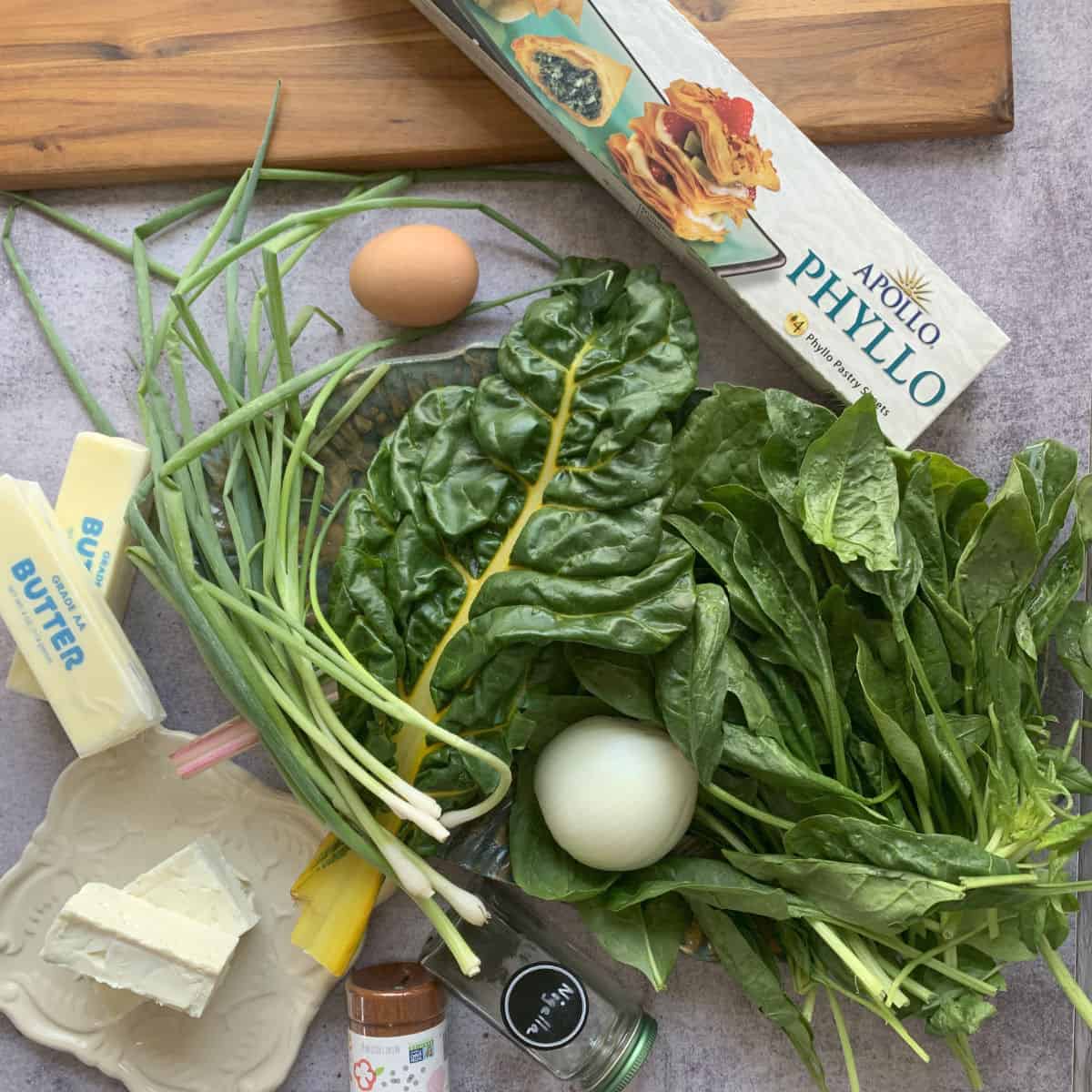Package of phyllo dough, spinach, chard, butter, feta and other ingredients. 