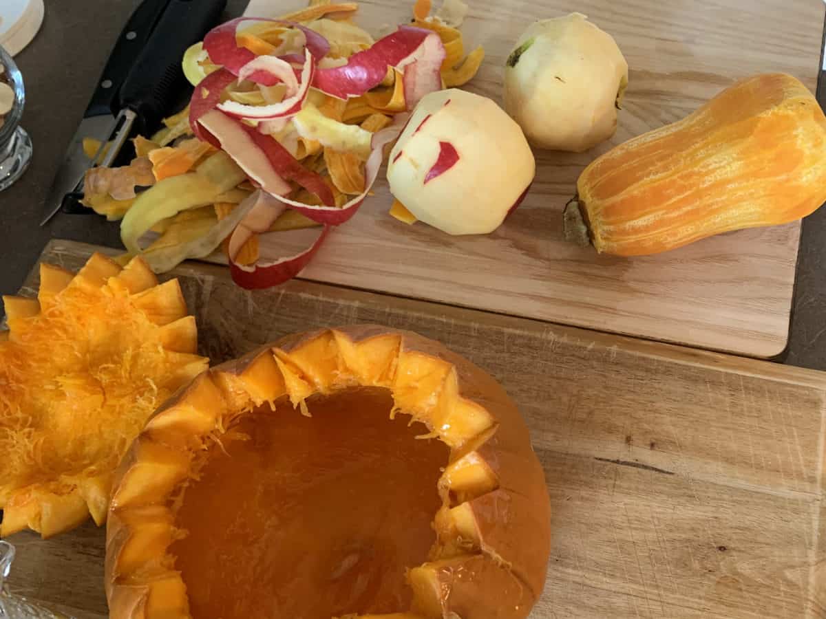 Peeled apples, quince, squash on a cutting board.
