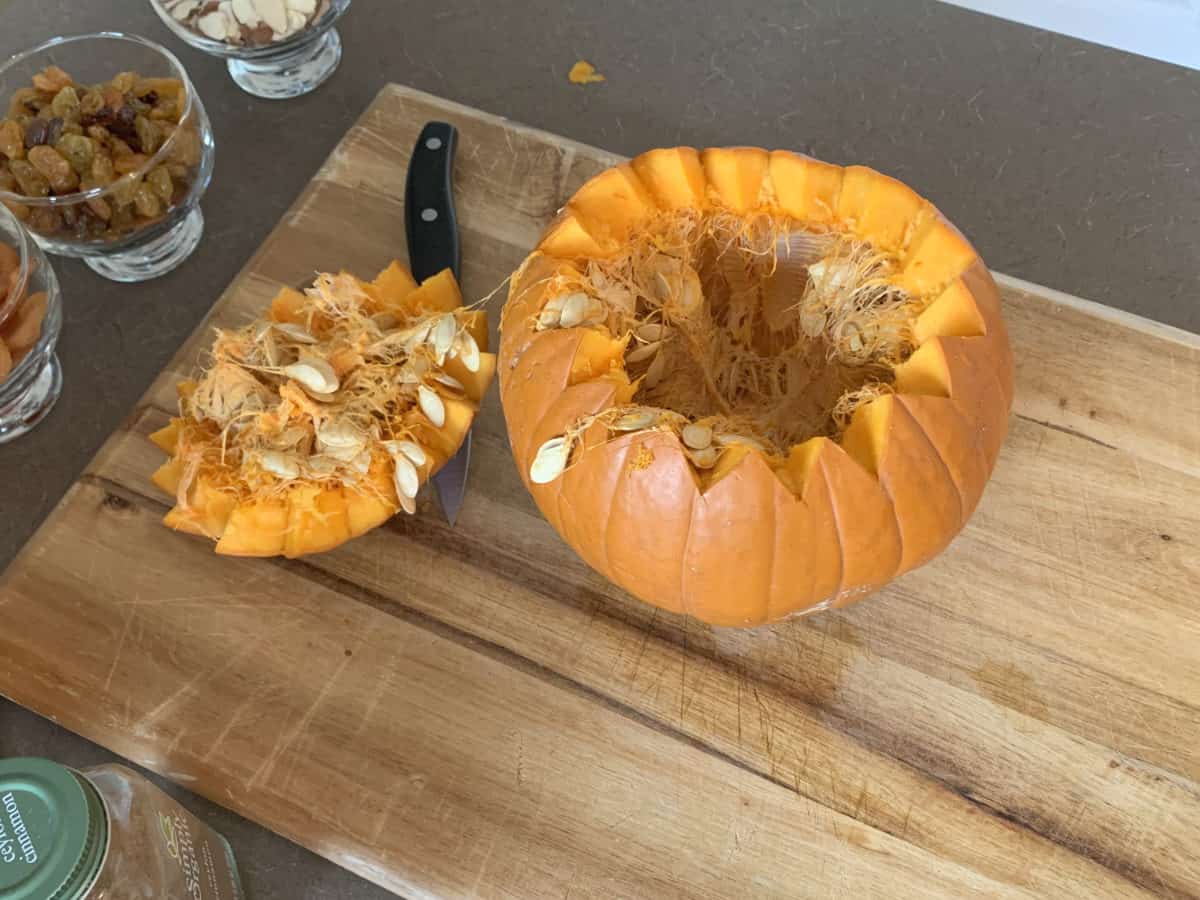 Cut pumpkin showing the inside and the lid.