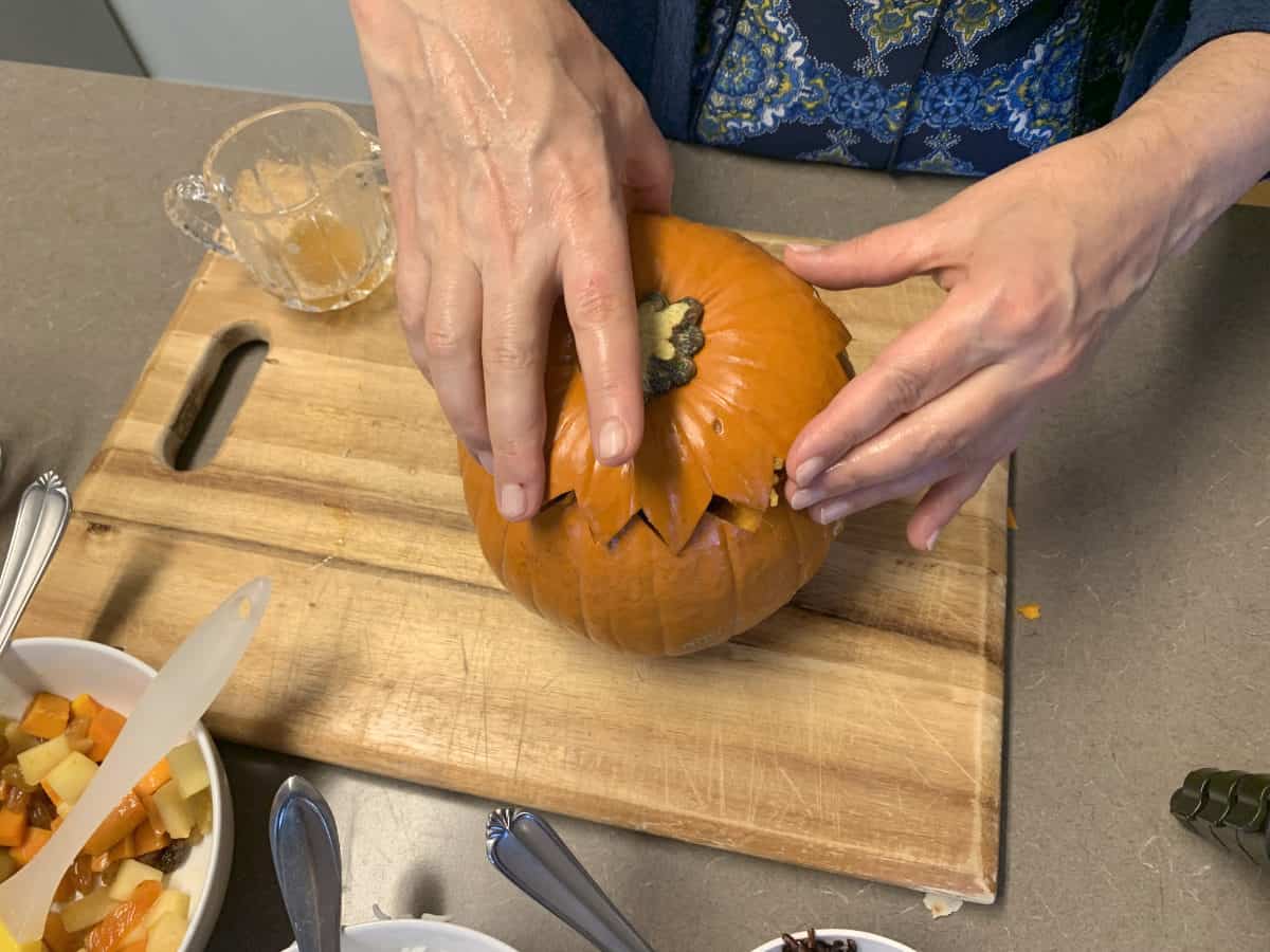 Cutting the top of the pumpkin.