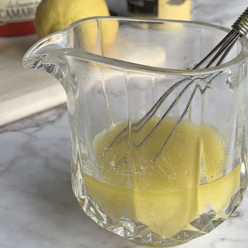 Mixing salad dressing in a jar.