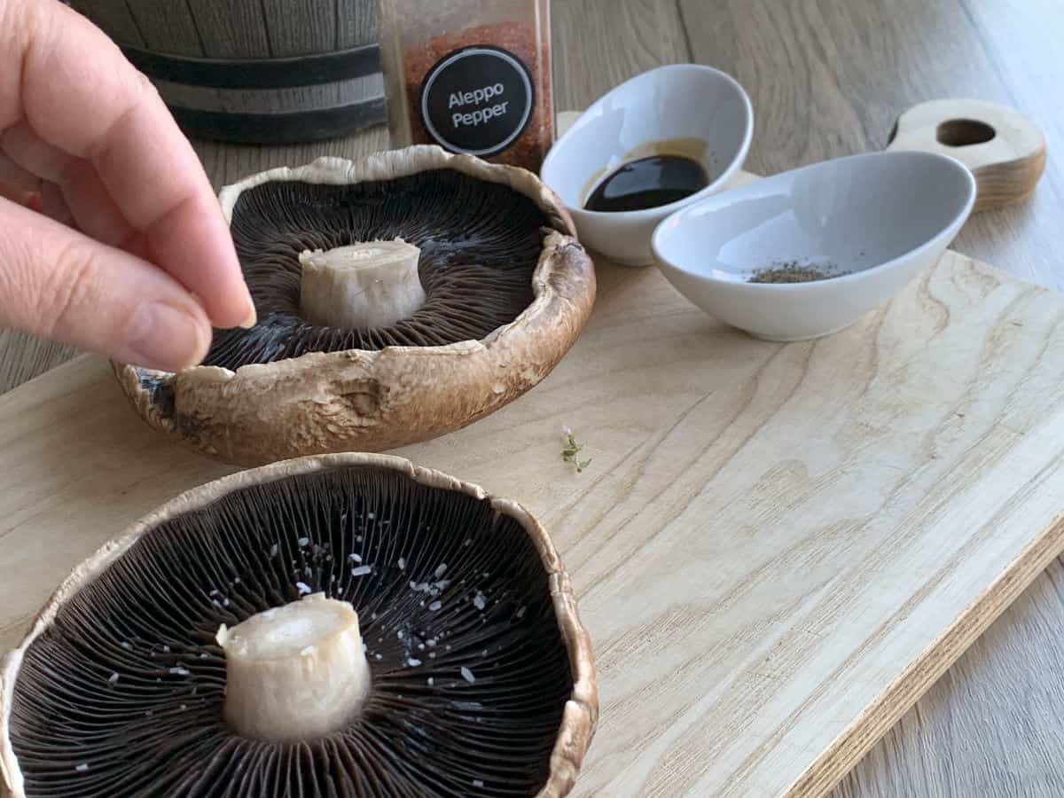Sprinkling mushrooms with salt.