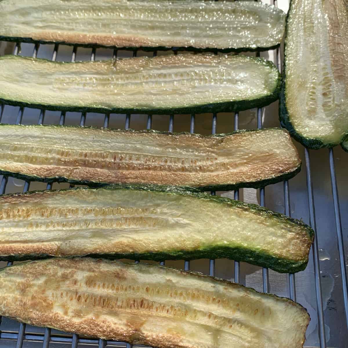 Fried zucchini on a wire rack.
