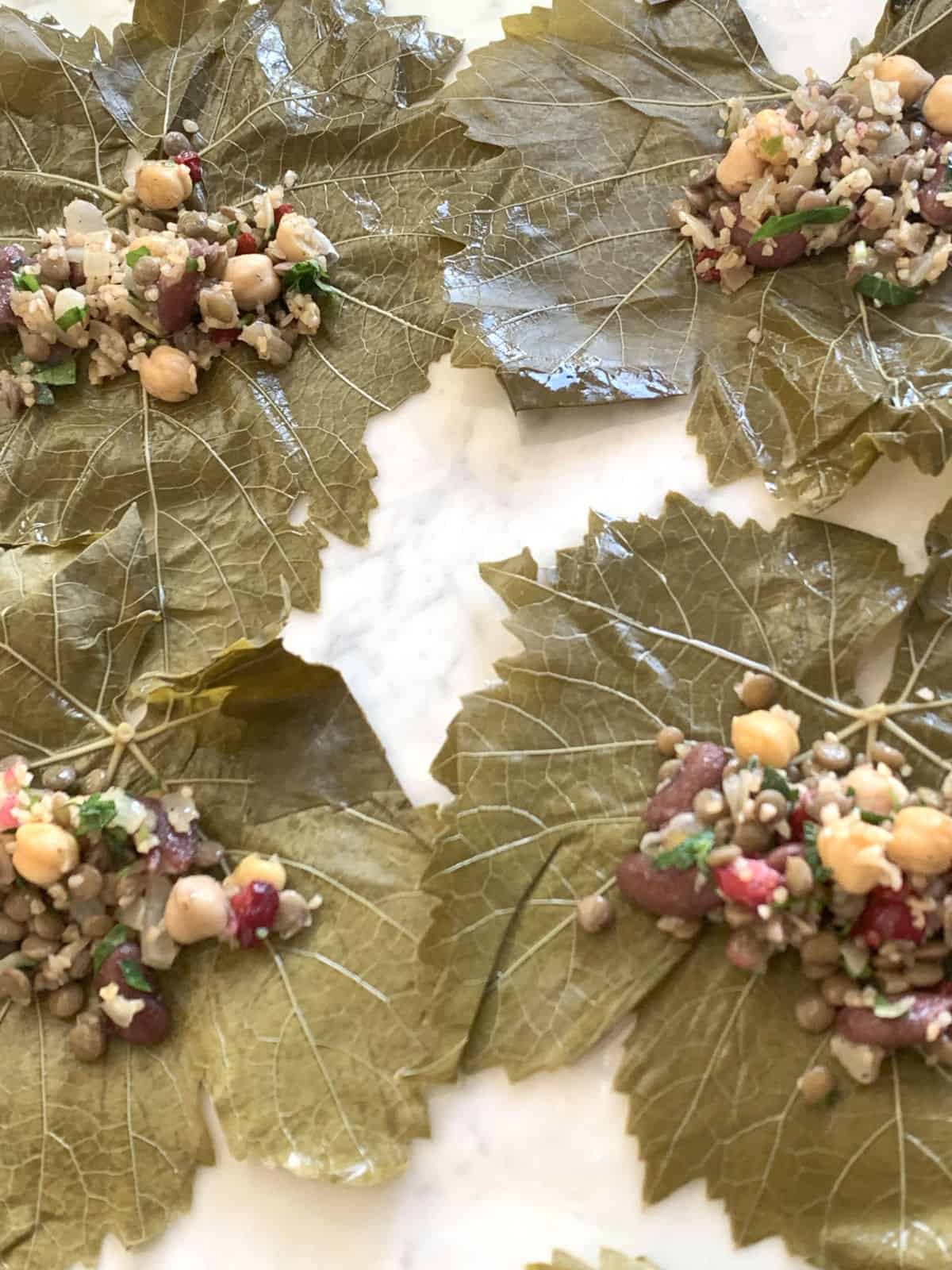 Grape leaves with bean stuffing ready to be rolled.