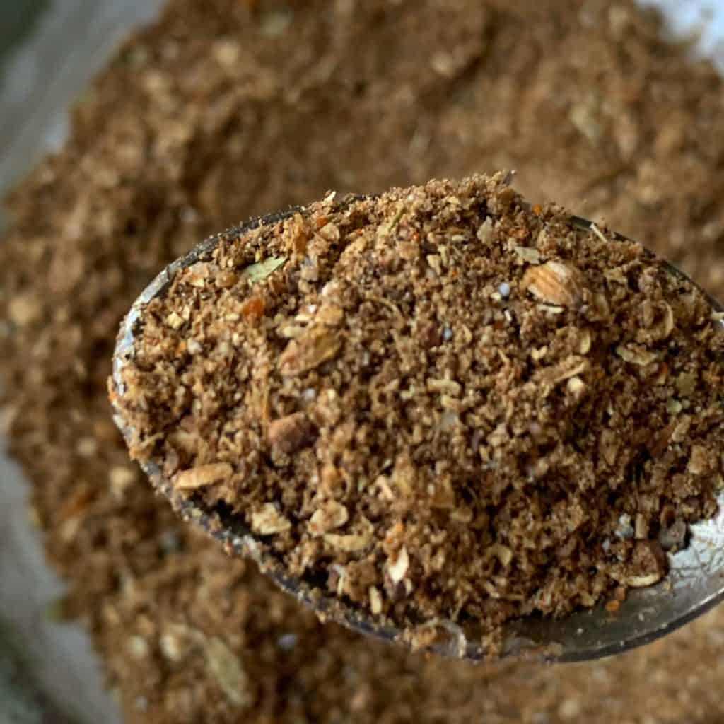 Garam Masala grounded spice close-up in a spoon