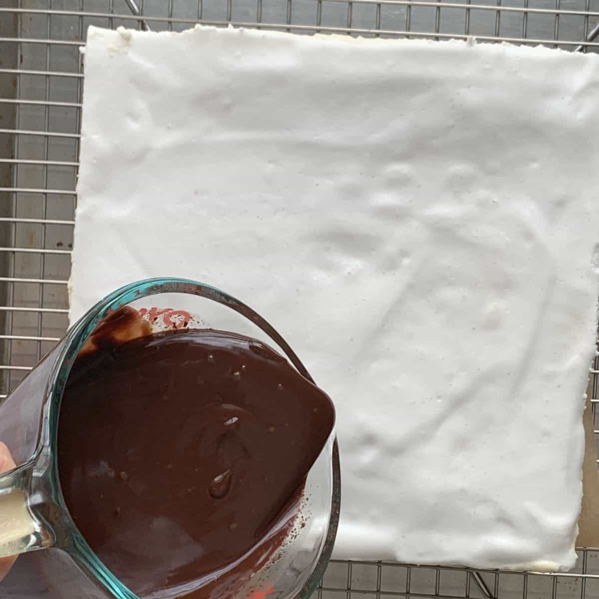 Assembling the cake by adding the glaze.