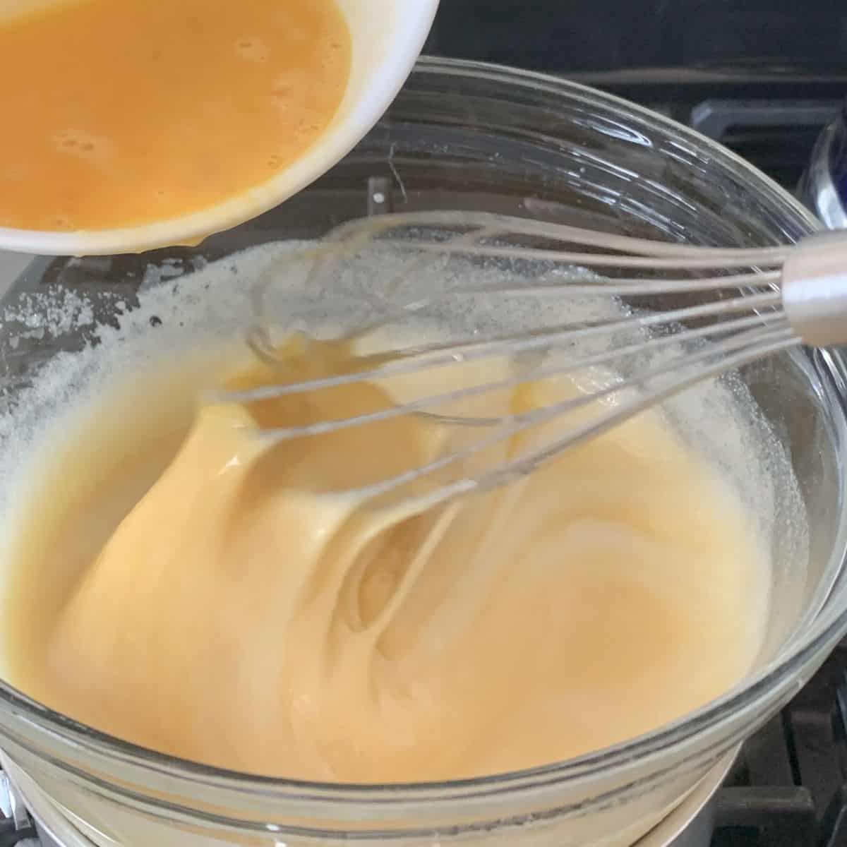 Adding the eggs to the batter. 