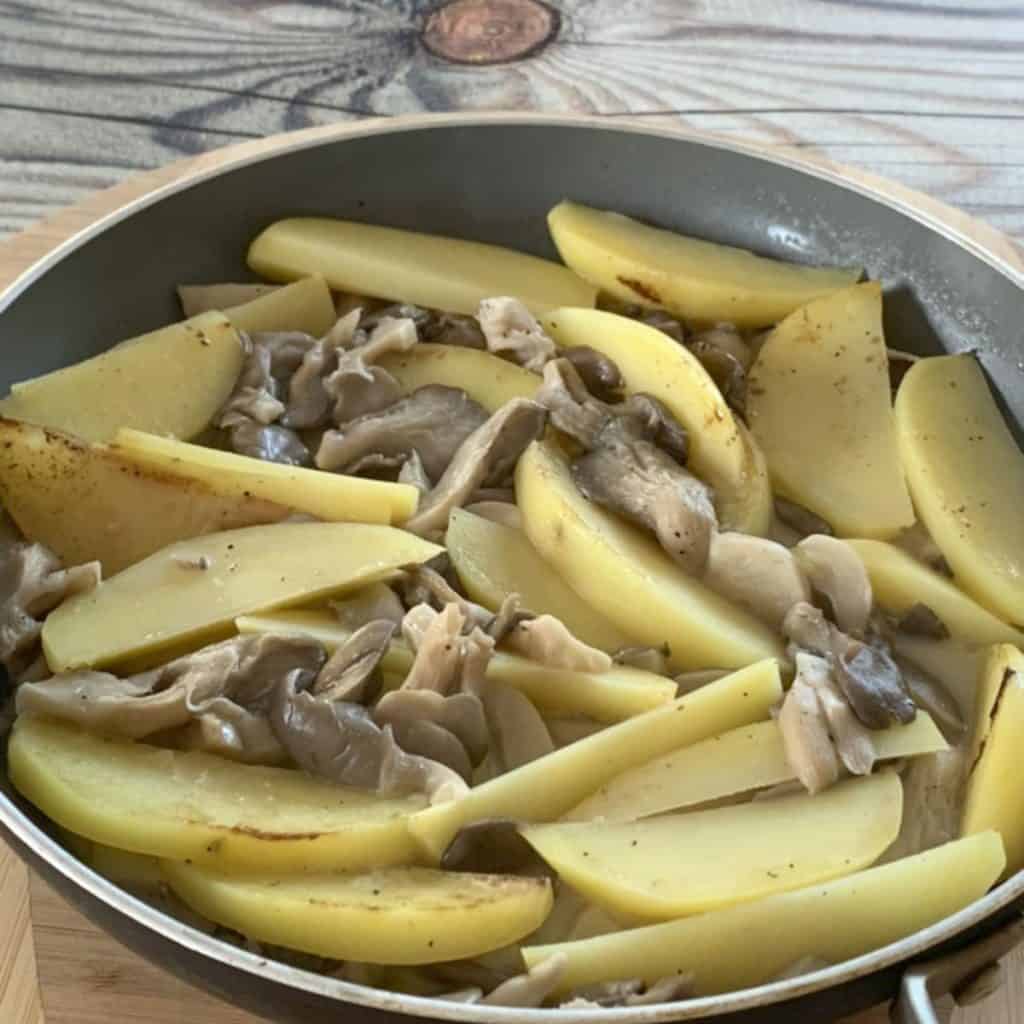 Oyster Mushroom and Potatoes in a saute pan.