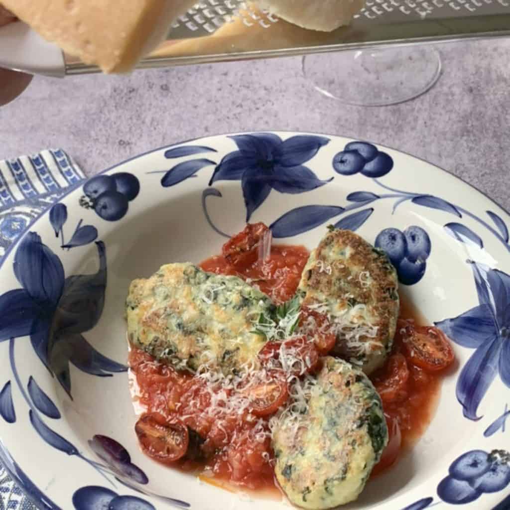 Ricotta kale gnocchi on blue plate.