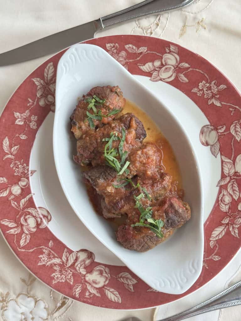 Overhead shot of the braciole in a dish.
