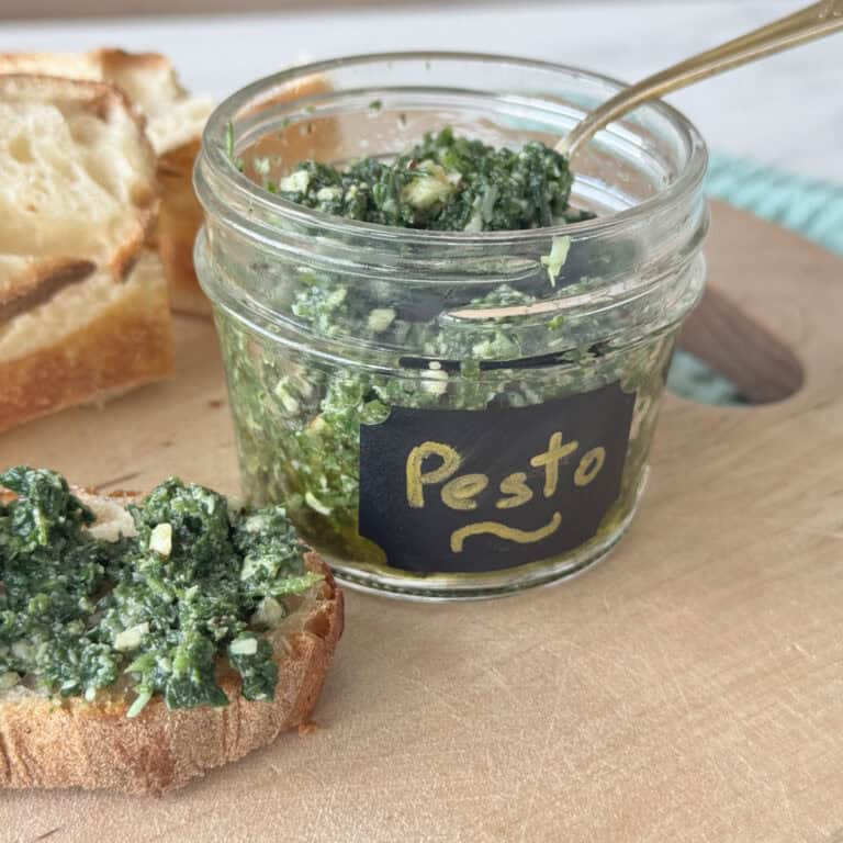 Nettle pesto spread on a bread and in the jar.
