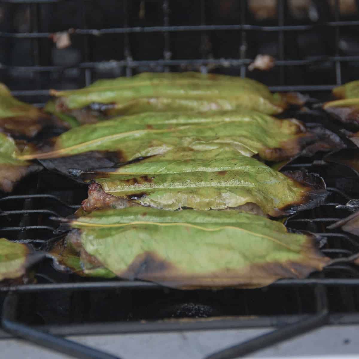 Meatballs are arranged in a grilling basket.