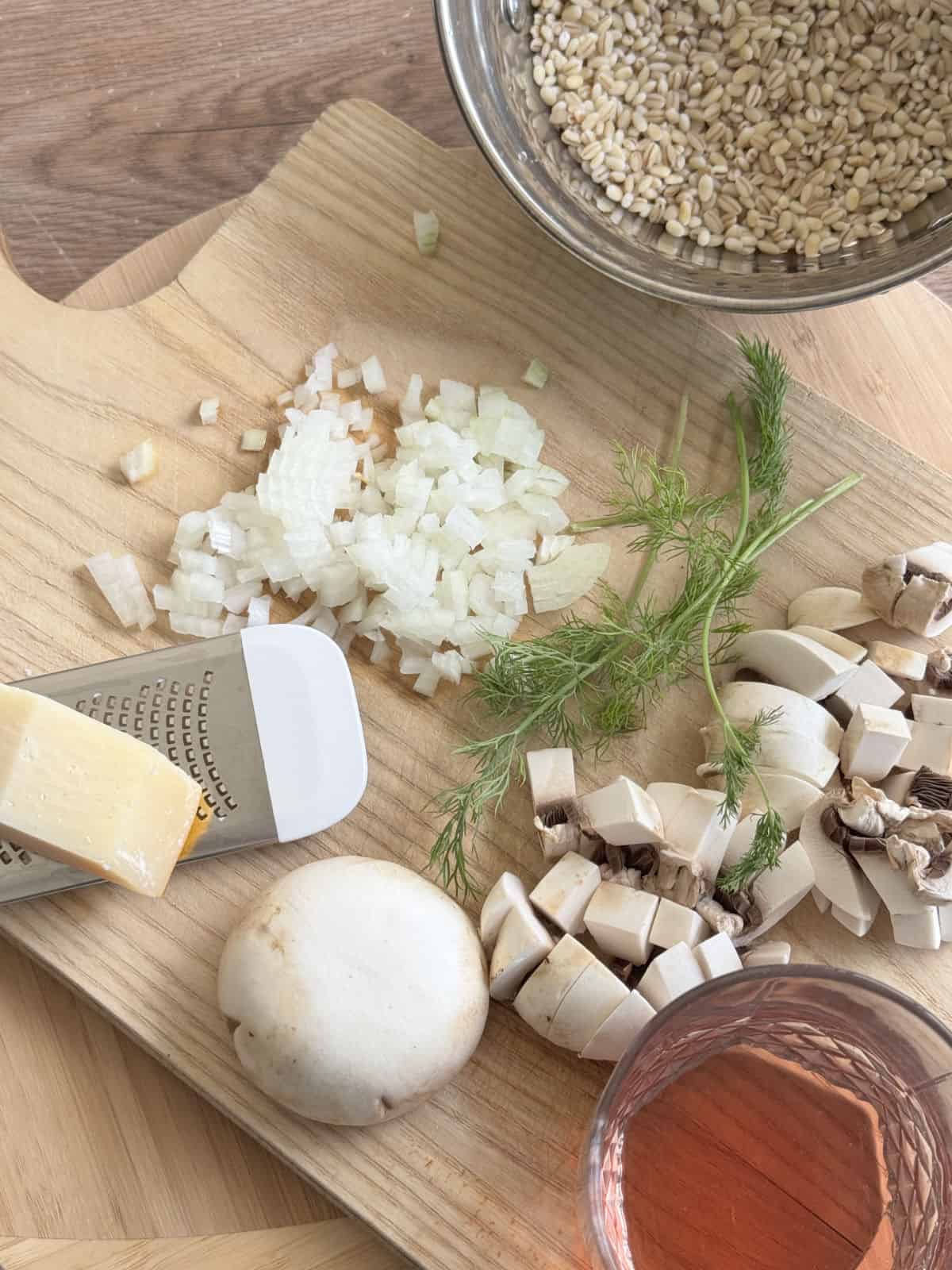 Mushrooms, pearl barley, dill, and other ingredients for mushroom barley risotto. 