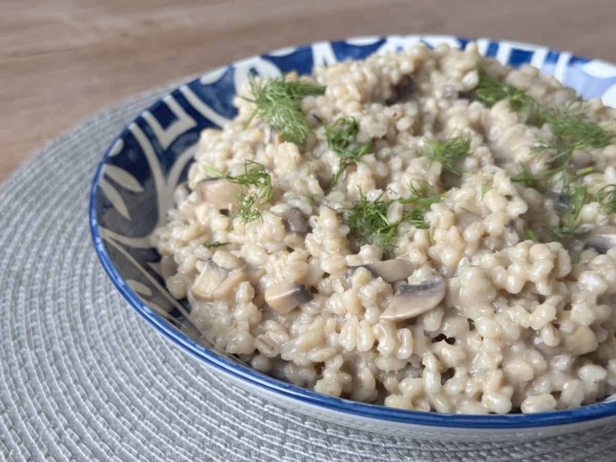 Barley risotto in a blue bowl.