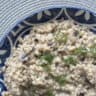 Close-up shot of a pearl barley risotto with chopped dill.