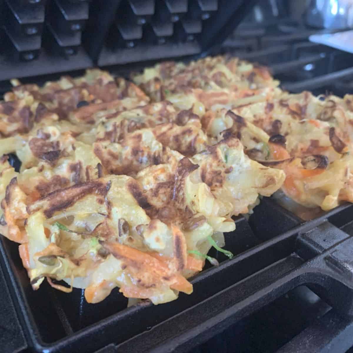 Making veggie waffles in a waffle iron.