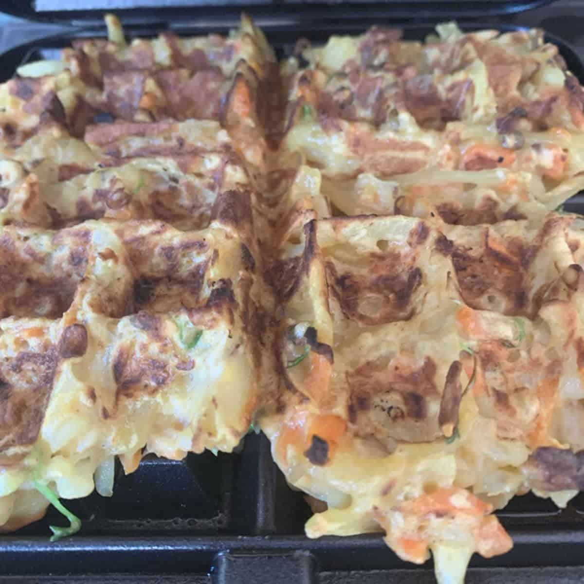 Making veggie waffles in a waffle iron.