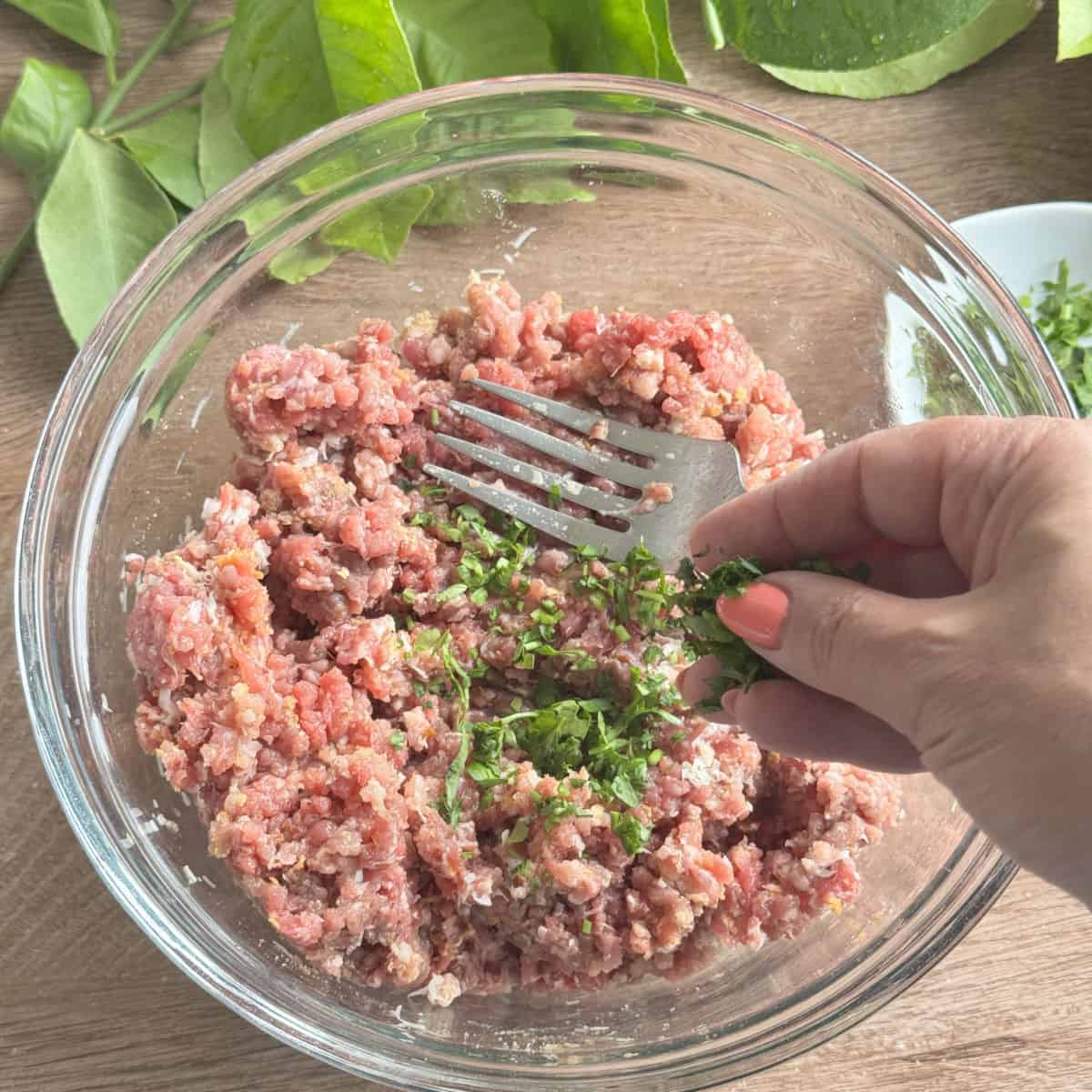 Adding parsley to the mixture.