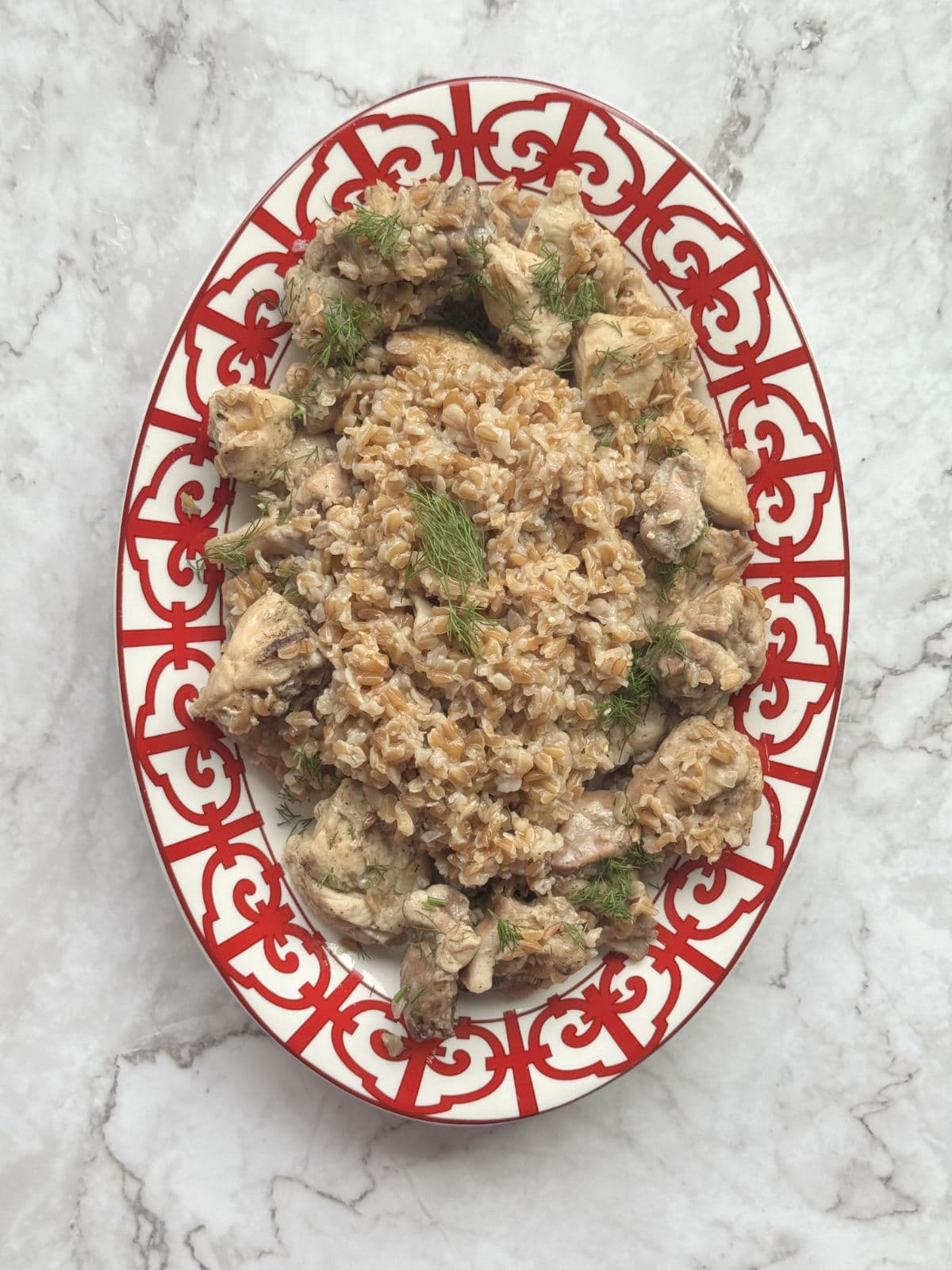 An overhead shot of a beautifully plated with farro pilaf with chicken.