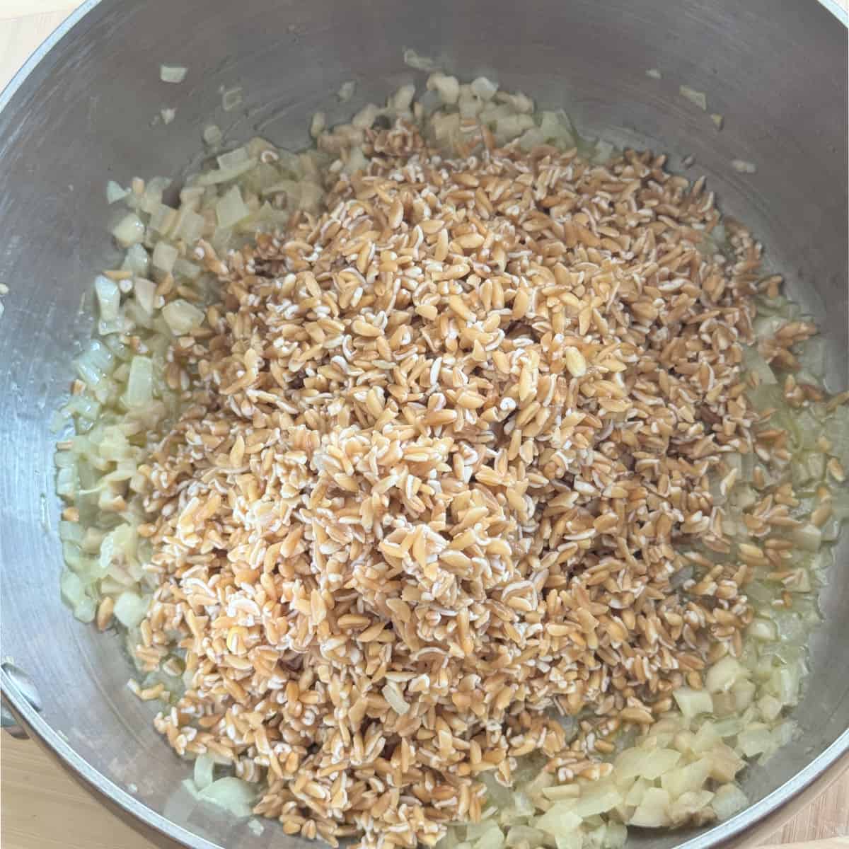 Mixing in farro with the onion mixture.