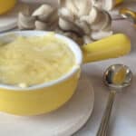 Creamy mushroom julienne in yellow mini cocotte with handle.